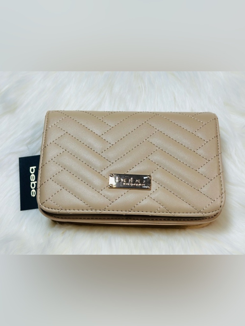 the Bebe Sophia Small Crossbody Bag in a taupe or beige color